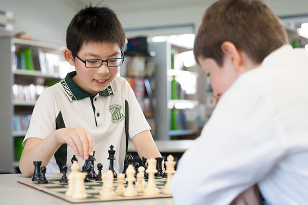 Students playing chess at St Peter Chanel Catholic Primary School Regents Park