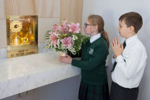 St Peter Chanel Catholic Primary School Regents Park students praying in front of the Relic of St Peter Chanel